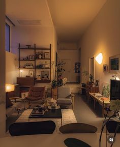 a living room filled with lots of furniture next to a wall mounted flat screen tv