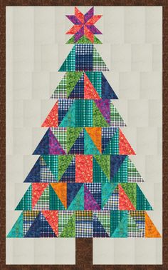 a quilted christmas tree is shown on the wall