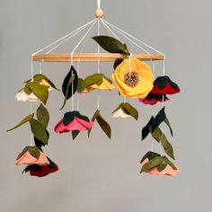 a mobile with flowers hanging from it's sides