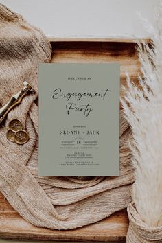 an engagement party is set up on a wooden tray next to a pair of scissors