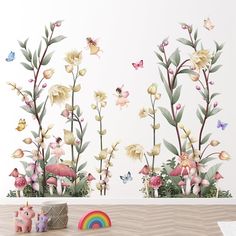 a wall mural with flowers and butterflies on it, next to a rainbow toy in the foreground