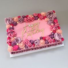 a birthday cake with pink and purple frosting