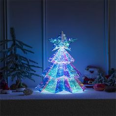 a lighted christmas tree in the middle of a room