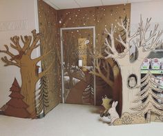 an open door to a room with paper cut trees