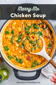 a pot full of chicken soup with spinach and cheese in it, on top of a