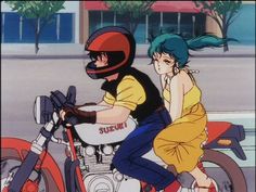 two people riding on the back of a motorcycle