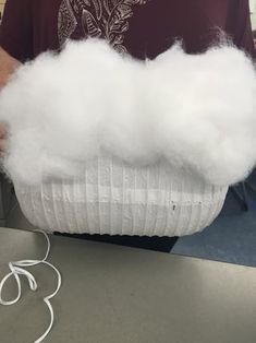 a person holding a basket with cotton in it