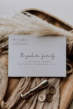 the wedding stationery is laid out on top of a pile of fur and other items