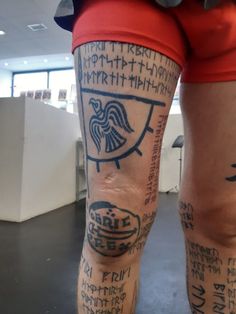 the legs and ankles of a person with tattoos on their legs, both covered in writing