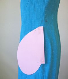 a blue dress with a piece of paper attached to the front and back of it