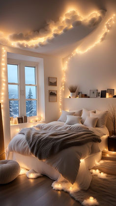 a bedroom with lights on the ceiling and a bed covered in white sheets, pillows and blankets