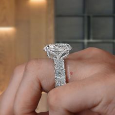 a person holding a diamond ring in their hand