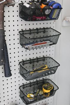 the pegboard is organized with wire baskets and tools to keep things organized in order