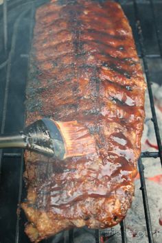 the meat is being cooked on the grill