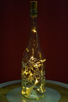 a lighted bottle sitting on top of a table