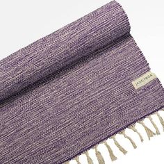 a purple and white blanket with fringes on it