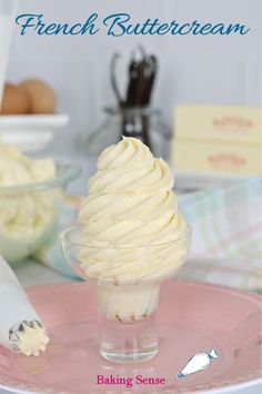 a pink plate topped with a scoop of vanilla ice cream