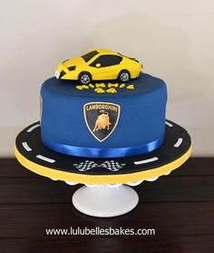 a blue cake with a yellow car on top