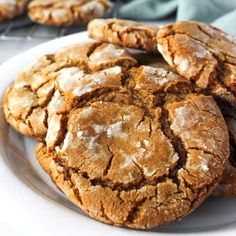 a white plate topped with cookies on top of a table next to candy canes