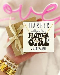 a hand holding a flower girl gift card