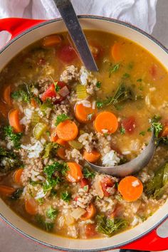 a bowl of soup with carrots, broccoli and other vegetables in it