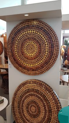 two circular baskets sitting on top of a white shelf next to each other in a room