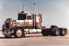 a large semi truck parked on top of a tarmac