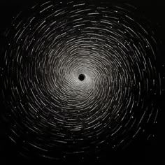 a black and white photo with stars in the sky, looking like a spiral pattern