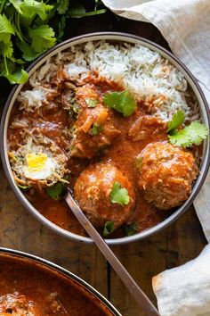 two bowls filled with meatballs, rice and cilantro on top of a wooden table