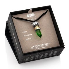 a star wars necklace in a box with the words luke sky walker written on it