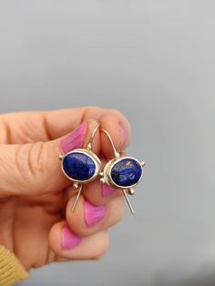 Wow! These are very pretty Handmade Earrings. They are made from Recycled Sterling Silver and oval Lapis Lazuli cabochons, and they are light and comfortable. Approximately 23mm long by 16mm wide. The cabochons themselves measure 12 mm X 10 mm each. Lapis Lazuli is a birthstone for September. The earrings will be a perfect present. Everything I sell is handmade by myself in my Wiltshire studio. Thank you for supporting handmade. Vintage Gold Earrings, Stamped Earrings, Cabochon Earrings, Lapis Earrings, Present For Her, Lapis Lazuli Earrings, Handmade Sterling Silver Rings, Romantic Jewellery, Evil Eye Earrings