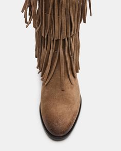 Upgrade your wardrobe with the SPUR fringe boot. These boots feature a fringe detailing that adds a touch of effortless style. Perfect for any occasion, these boots will elevate your look while providing comfort and durability. 1 inch heel height 14.5 inch shaft circumference 15 inch shaft height Suede upper material Synthetic lining Leather sock Synthetic sole Fit tip: If you are in between sizes, size up a half-size Imported Casual Leather Fringe Boots, Leather Fringe Boots For Fall, Winter Fringe Ankle Boots, Casual Suede Fringe Boots, Western Suede Fringe Boots, Western Style Suede Boots With Fringe, Western Boots With Tassels For Fall, Western Style Boots With Tassels For Fall, Western Fringe Boots For Fall