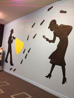 the wall is decorated with silhouettes of people holding umbrellas