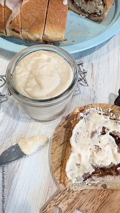 two slices of bread with icing on them sitting next to a bowl of pudding