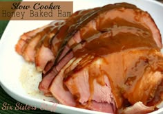 slow cooker honey baked ham on top of rice in a white bowl with caramel sauce