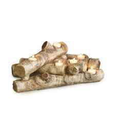 some logs with candles in them on a white background