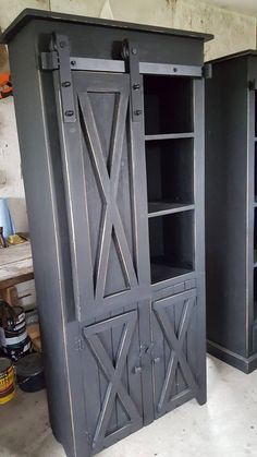 two black cabinets sitting next to each other in a room