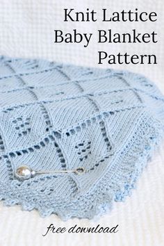 a knitted blanket with a pin on it and text overlay that says knitting baby blanket pattern