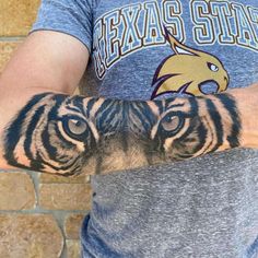 a man with a tiger tattoo on his arm