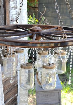 mason jar chandelier with chains hanging from it's sides and glass jars in the middle