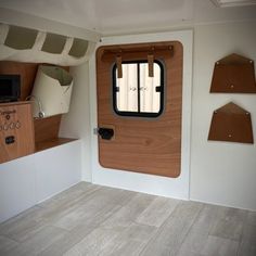 the interior of an rv with wooden doors and windows