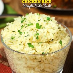 a glass bowl filled with rice on top of a wooden table