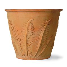 a clay planter with leaves carved on the outside and inside, is shown against a white background