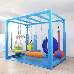 an indoor play area with swings and toys