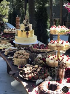 a table topped with lots of different types of cakes and desserts on top of it