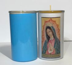 a candle that is sitting next to a canister with the image of mary of guadalupe on it