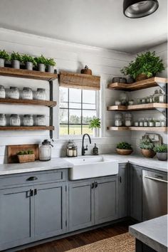 Eclectic farmhouse kitchen with mixed cabinet styles and barn door Farmhouse Kitchen With Gray Cabinets, Farmhouse Kitchen With Painted Cabinets, Open Upper Kitchen Cabinets, Grey And White Kitchens, Open Cabinet Kitchen, Kitchen With No Upper Cabinets, Blue Farmhouse Kitchen, Costal Farmhouse, Affordable Farmhouse Kitchen