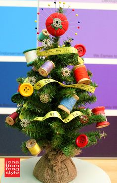 a small christmas tree decorated with buttons and ribbons