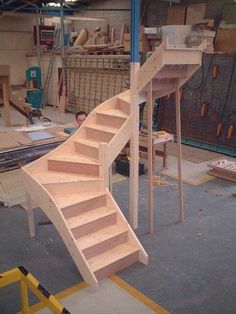 a wooden staircase being built in a workshop