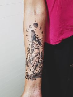 a woman's arm with a tattoo on it and a cross in the middle